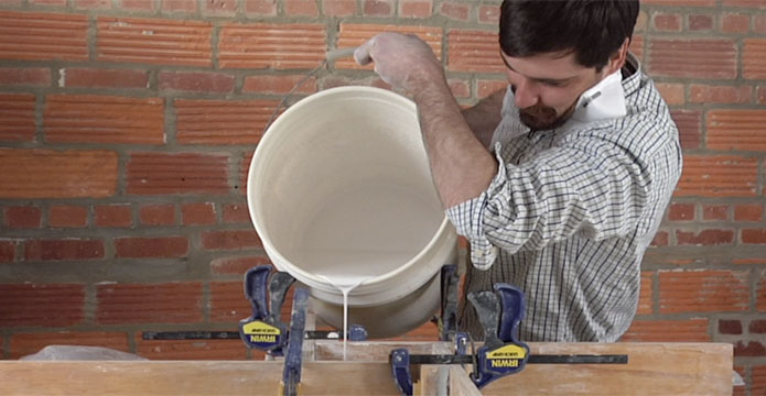 Guy Michael Davis shows how to pour plaster to make a mold for pottery.