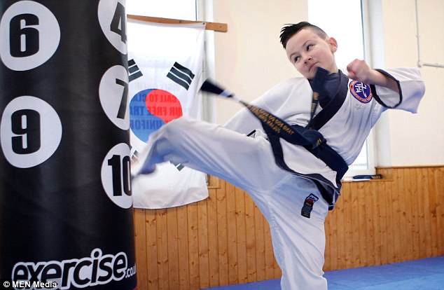 Julian trains with chief instructor Peter Watt at the Family Martial Arts Centre in Swinton