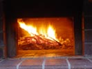 Making and maintaining fires in wood brick ovens.
