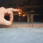Firing up bakery wood burning brick oven.